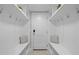 Well-organized mudroom with storage cubbies, hooks, seating, and neutral tiled floor and access to garage at 418 Wyndham Drive, Chapel Hill, NC 27516