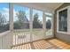 View from the screened porch to the backyard, featuring a fire pit and verdant trees at 418 Wyndham Drive, Chapel Hill, NC 27516