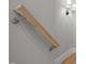 Close up of a modern light wood stair railing with brushed nickel hardware and sconce lighting at 418 Wyndham Drive, Chapel Hill, NC 27516