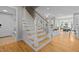 Elegant staircase with wooden treads and white railings, leading to an open-concept living space at 418 Wyndham Drive, Chapel Hill, NC 27516