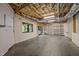 Unfinished basement space with concrete floor, exposed ceiling, walkout door and built-in shelving at 4312 Mystic Ln, Hillsborough, NC 27278