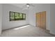 Bright bedroom with a large window, neutral carpet, and wood closet doors at 4312 Mystic Ln, Hillsborough, NC 27278