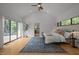Bright bedroom with vaulted ceiling, wood floors, and sliding glass door to deck at 4312 Mystic Ln, Hillsborough, NC 27278
