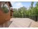 Spacious wood deck with black railings overlooks scenic trees and landscaping at 4312 Mystic Ln, Hillsborough, NC 27278