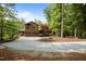 Spacious home with a three-car garage and a circular driveway surrounded by trees at 4312 Mystic Ln, Hillsborough, NC 27278