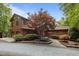 Charming multi-story home featuring wood siding, lush landscaping, mature trees and a circular driveway at 4312 Mystic Ln, Hillsborough, NC 27278