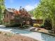 Charming home featuring a well-manicured front yard with mature landscaping, a gravel driveway and a welcoming entrance at 4312 Mystic Ln, Hillsborough, NC 27278