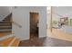 Hallway leading to a powder room and a living room with a stone fireplace and wood floors at 4312 Mystic Ln, Hillsborough, NC 27278