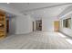 Large living room with neutral carpet, recessed lighting, and wood accents, with multiple doorways at 4312 Mystic Ln, Hillsborough, NC 27278
