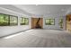 Large living room with a wood burning stove, neutral carpet, recessed lighting, wood accents and an outdoor exit at 4312 Mystic Ln, Hillsborough, NC 27278