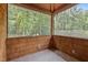 Enclosed porch with wood paneled walls and tile floor offers a cozy outdoor space at 4312 Mystic Ln, Hillsborough, NC 27278