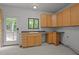 Well-lit utility room with cabinetry, sink, and exterior access at 4312 Mystic Ln, Hillsborough, NC 27278