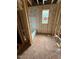 An unfinished bathroom with exposed wooden beams and window, with a tub installed at 444 Golden Dragonfly St, Wake Forest, NC 27587