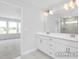 Bathroom featuring double sinks and a shower with a window at 444 Golden Dragonfly St, Wake Forest, NC 27587