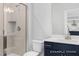 Modern bathroom featuring a glass-enclosed shower and vanity with navy blue drawers at 444 Golden Dragonfly St, Wake Forest, NC 27587