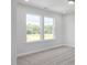 Bedroom with carpet flooring and two windows overlooking the greenery outside, creating a bright and airy feel at 444 Golden Dragonfly St, Wake Forest, NC 27587