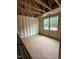 An unfinished bedroom with insulation, exposed beams, and natural light from two windows at 444 Golden Dragonfly St, Wake Forest, NC 27587