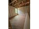 Bedroom under construction showcasing insulation, exposed wooden beams, and a window at 444 Golden Dragonfly St, Wake Forest, NC 27587