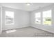 Bright bedroom with carpet and two large windows, offering natural light and backyard views at 444 Golden Dragonfly St, Wake Forest, NC 27587