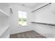 Walk-in closet with built-in shelving and clothing rods, and a window at 444 Golden Dragonfly St, Wake Forest, NC 27587