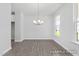 Bright dining room with wood floors, elegant chandelier, and large windows at 444 Golden Dragonfly St, Wake Forest, NC 27587