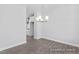 Spacious dining area with sleek wood floors, modern lighting, and a glimpse of the kitchen at 444 Golden Dragonfly St, Wake Forest, NC 27587