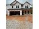 New construction featuring a covered front porch and attached garage, ready for finishing touches at 444 Golden Dragonfly St, Wake Forest, NC 27587