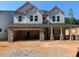 Craftsman-style home featuring stone accents and a welcoming covered porch, blending elegance with modern design at 444 Golden Dragonfly St, Wake Forest, NC 27587