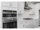 Gourmet kitchen featuring stainless steel appliances, stylish backsplash, and white cabinetry at 444 Golden Dragonfly St, Wake Forest, NC 27587