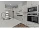 Modern kitchen featuring stainless steel appliances, white cabinets, and sleek countertops at 444 Golden Dragonfly St, Wake Forest, NC 27587