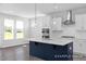 Modern kitchen featuring white cabinetry, stainless steel appliances, a large island with pendant lights, and a view of the outdoors at 444 Golden Dragonfly St, Wake Forest, NC 27587
