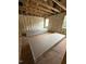 Unfinished living room showcasing insulation, exposed wooden beams, and multiple windows at 444 Golden Dragonfly St, Wake Forest, NC 27587