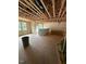 Unfinished living room with exposed studs and large windows, ready for customization at 444 Golden Dragonfly St, Wake Forest, NC 27587