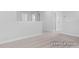 Open loft area with carpet and white walls, offering flexible space for living or recreation at 444 Golden Dragonfly St, Wake Forest, NC 27587