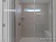 Modern shower stall featuring sleek tile, built in shower bench, and glass door at 444 Golden Dragonfly St, Wake Forest, NC 27587