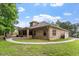 Brick home backyard featuring a lush green lawn, paved walkway, and brick patio, perfect for outdoor enjoyment at 46 Spring Haven Ln, Willow Springs, NC 27592