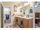 Bathroom featuring a double sink vanity, decorative mirror, and ample cabinet space at 46 Spring Haven Ln, Willow Springs, NC 27592