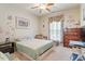 Inviting guest bedroom with floral accents, comfortable bed, and stylish window coverings at 46 Spring Haven Ln, Willow Springs, NC 27592