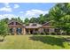 Charming brick home featuring a lush green lawn and mature landscaping at 46 Spring Haven Ln, Willow Springs, NC 27592