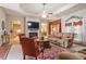 Spacious living room boasts fireplace, modern ceiling fan, and plenty of natural light at 46 Spring Haven Ln, Willow Springs, NC 27592