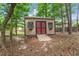 Outdoor storage shed with ramp and double doors, perfect for tools, gardening, and external storage at 46 Spring Haven Ln, Willow Springs, NC 27592