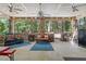 Spacious screened-in porch with comfortable seating, ceiling fans, and access to outdoor spaces at 46 Spring Haven Ln, Willow Springs, NC 27592