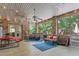 Relaxing sunroom with brick accents, ceiling fans, and views of the wooded backyard at 46 Spring Haven Ln, Willow Springs, NC 27592