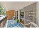 Private balcony with brick accents, sliding glass doors, and a patterned blue rug adds charm to this living space at 4709 Edwards Mill Rd # H, Raleigh, NC 27612