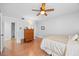 Bright bedroom with hardwood floors, a ceiling fan, and a chest of drawers at 4709 Edwards Mill Rd # H, Raleigh, NC 27612