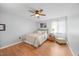 Bright bedroom with hardwood floors, a ceiling fan, and a view of the backyard at 4709 Edwards Mill Rd # H, Raleigh, NC 27612