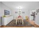 Charming dining room with a modern chandelier and view into the adjacent eat-in kitchen at 4709 Edwards Mill Rd # H, Raleigh, NC 27612