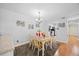 Bright dining room featuring hardwood floors, a modern table set, and an eat-in kitchen at 4709 Edwards Mill Rd # H, Raleigh, NC 27612