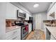 Updated kitchen features stainless steel appliances, granite countertops, and a stylish backsplash at 4709 Edwards Mill Rd # H, Raleigh, NC 27612