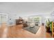 Bright living room features hardwood flooring, a sliding door, and comfortable seating arrangements at 4709 Edwards Mill Rd # H, Raleigh, NC 27612